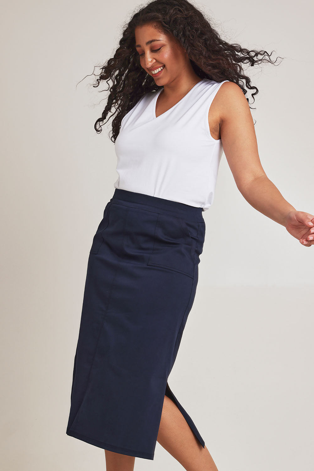 Model Terri-Leigh wearing size 14 of The Tencel Blend Pull On  Skirt in colour Navy (Blue), from the front, cropped image