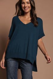 Model Madeline wearing size S of The All Season V Neck High Low Tee in colour Blueocean (Blue), from the front, showing the whole outfit