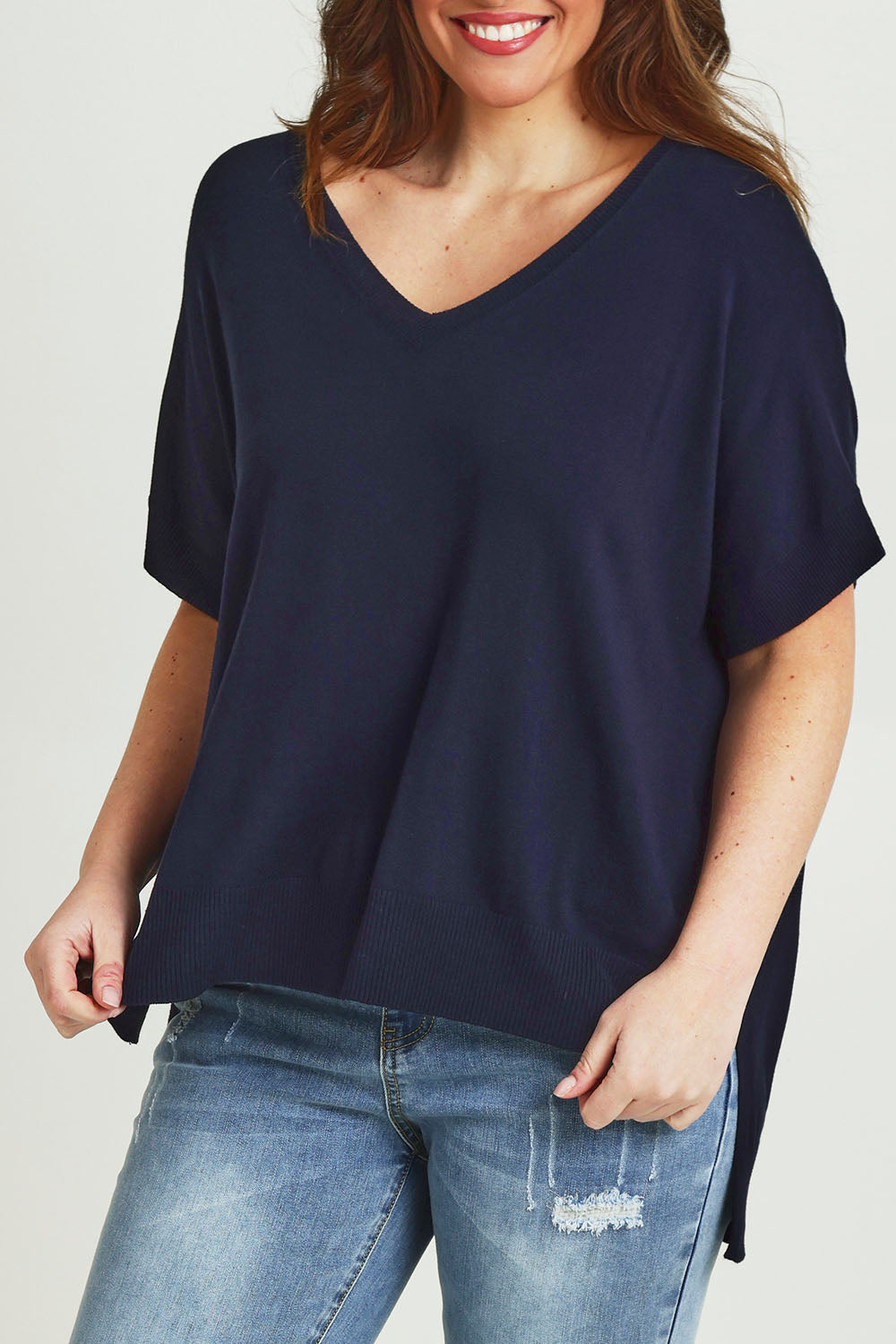 Model Jane wearing size L of The All Season V Neck High Low Tee in colour Darklapis (Blue), from the front, cropped image