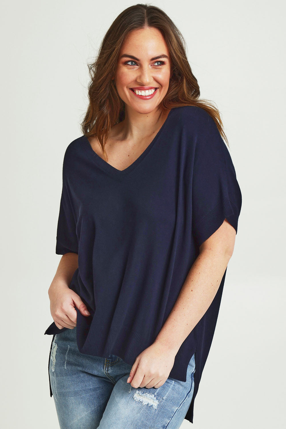 Model Jane wearing size L of The All Season V Neck High Low Tee in colour Darklapis (Blue), from the front, cropped image