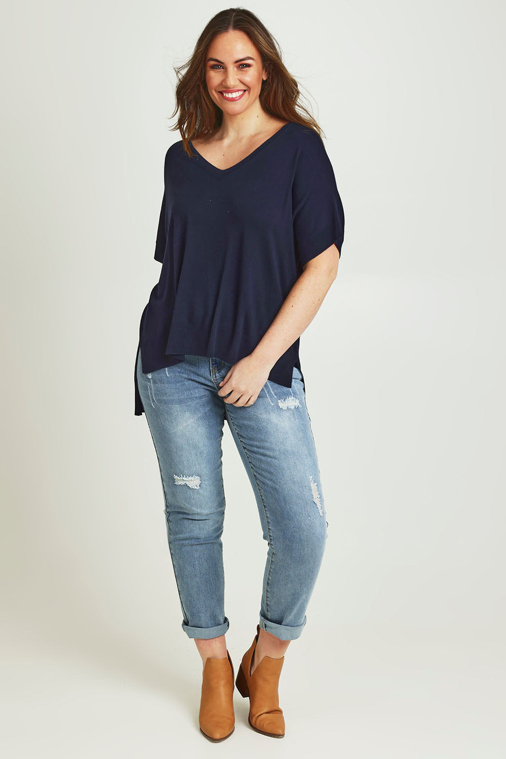 Model Jane wearing size L of The All Season V Neck High Low Tee in colour Darklapis (Blue), from the front, showing the whole outfit