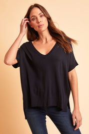 Model Madeline wearing size S of The All Season V Neck High Low Tee in colour Darklapis (Blue), from the front, showing the whole outfit