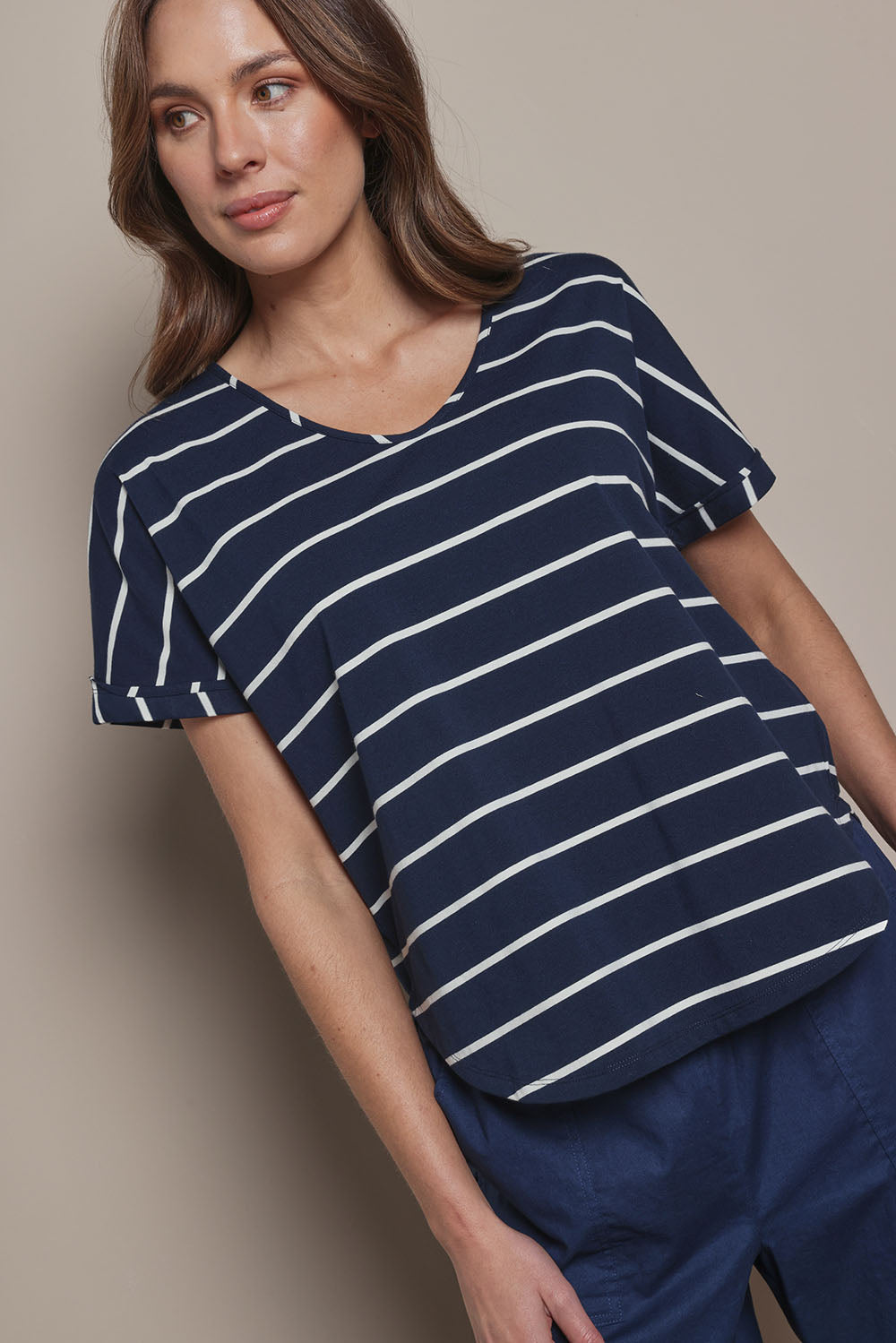 Model Madeline wearing size 10 of The Striped V Neck Tee in colour Navywhite (Blue), from the front, cropped image