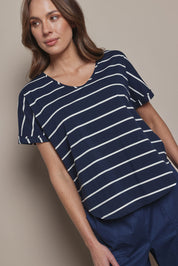 Model Madeline wearing size 10 of The Striped V Neck Tee in colour Navywhite (Blue), from the front, cropped image