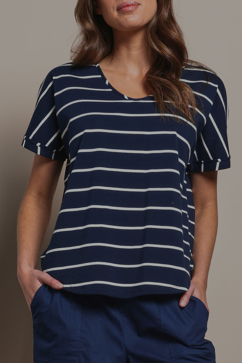 Model Madeline wearing size 10 of The Striped V Neck Tee in colour Navywhite (Blue), from the front, cropped image