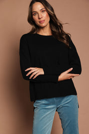 Model Madeline wearing size S of The Modal Blend Crew Neck Jumper in colour Black (Black), from the front, showing the whole outfit