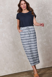 Model Madeline wearing size 10 of The Striped Pull On Skirt in colour Navystripe (Blue), from the front, showing the whole outfit