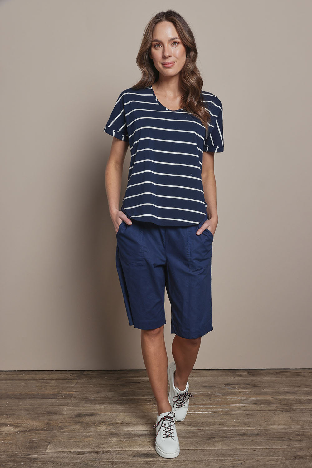 Model Madeline wearing size 10 of The Rib Waistband Short in colour Navy (Blue), from the front, showing the whole outfit