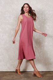 Model Madeline wearing size 10 of The Cotton Flounce Dress in colour Rose (Pink), from the front, showing the whole outfit