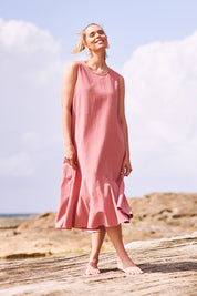 Model Phoebe wearing size 10 of The Cotton Flounce Dress in colour Rose (Pink), from the front, showing the whole outfit