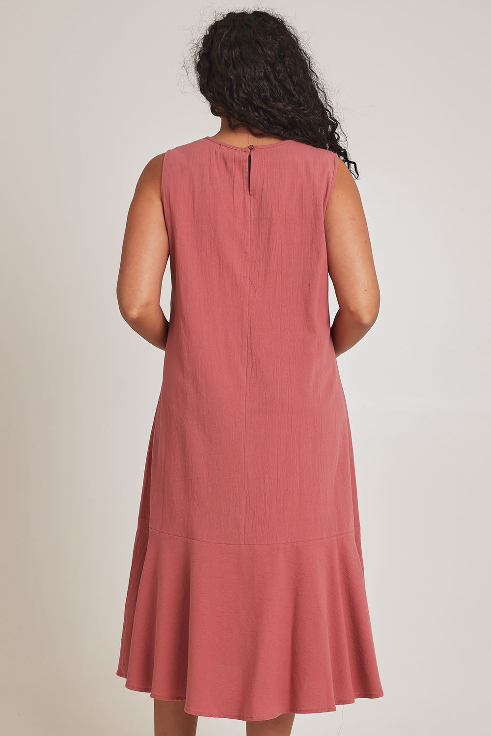 Model Terri-Leigh wearing size 14 of The Cotton Flounce Dress in colour Rose (Pink), from the back