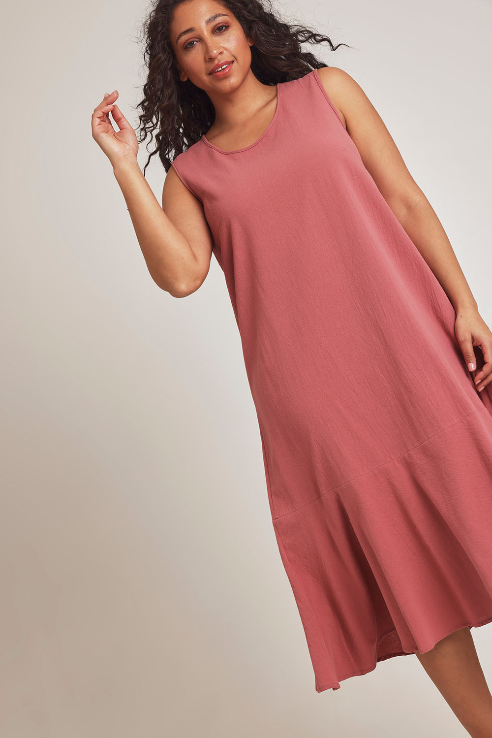 Model Terri-Leigh wearing size 14 of The Cotton Flounce Dress in colour Rose (Pink), from the front, cropped image