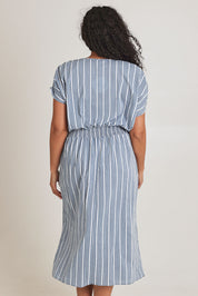 Model Terri-Leigh wearing size 14 of The Cotton Shirred Waist Dress in colour Denimblue (Blue), from the back