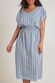 Model Terri-Leigh wearing size 14 of The Cotton Shirred Waist Dress in colour Denimblue (Blue), from the front, cropped image