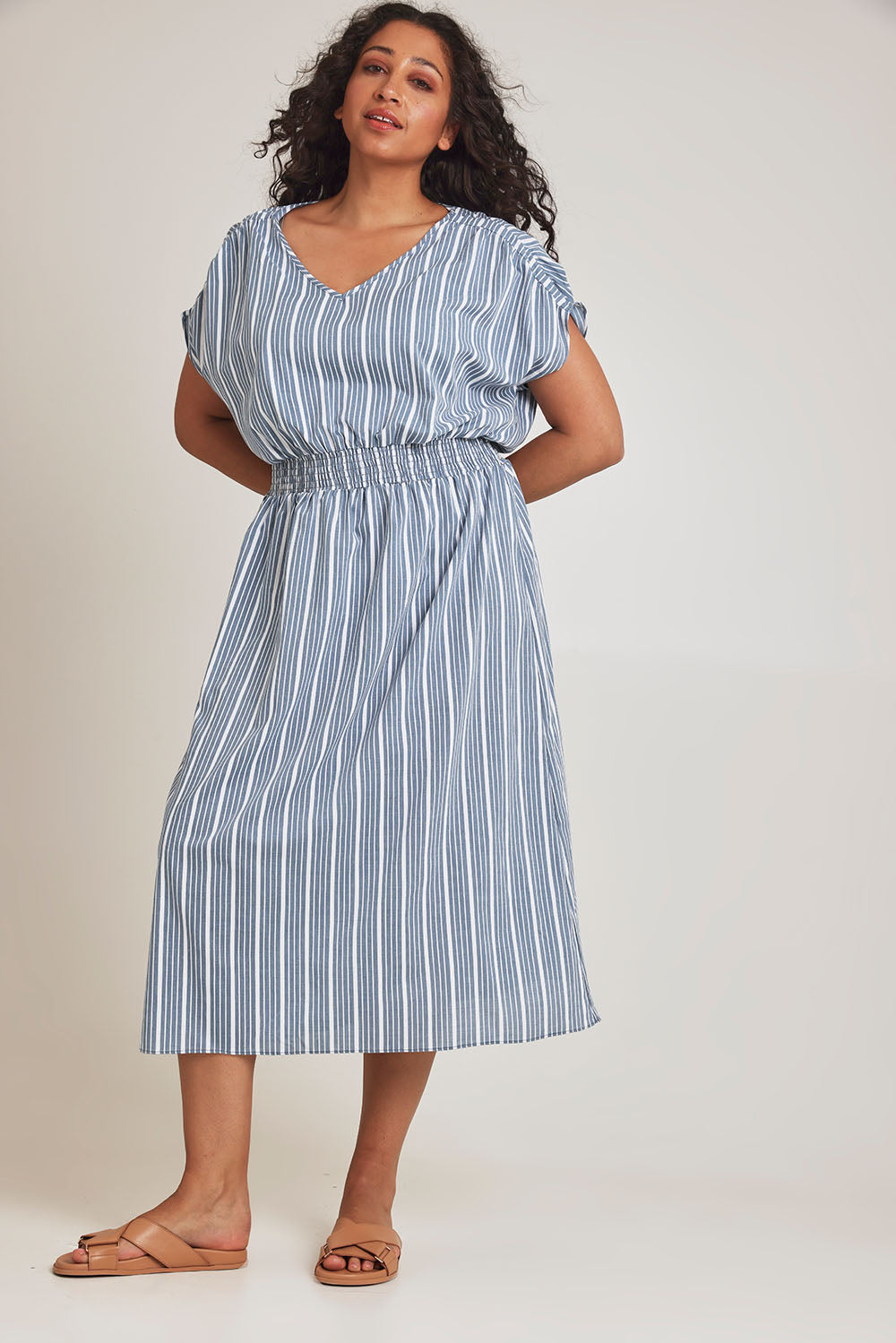 Model Terri-Leigh wearing size 14 of The Cotton Shirred Waist Dress in colour Denimblue (Blue), from the front, showing the whole outfit