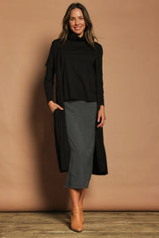Model Madeline wearing size 10 of The Pack & Go Luxe Bamboo Button Up Dress with Pockets in colour Black (Black), from the front, showing the whole outfit