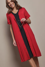 Model Madeline wearing size 10 of The Pack & Go Luxe Bamboo Button Up Dress with Pockets in colour Cherryred (Red), from the front, cropped image