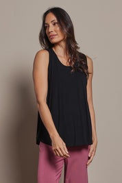 Model Amanda wearing size 10 of The Pack & Go Luxe Bamboo Swing Tank in colour Black (Black), from the front, cropped image