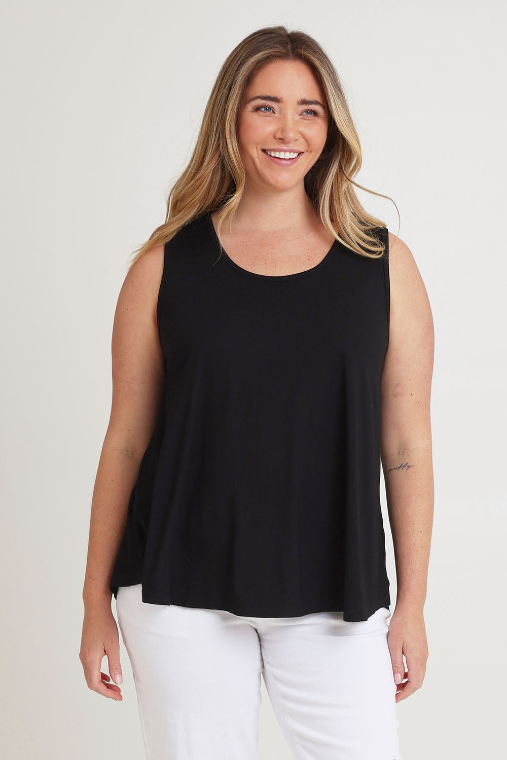 Model Chanel wearing size 16 of The Pack & Go Luxe Bamboo Swing Tank in colour Black (Black), from the front, cropped image