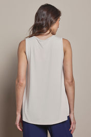 Model Madeline wearing size 10 of The Pack & Go Luxe Bamboo Swing Tank in colour Nougat, from the back