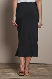 Model Madeline wearing size 10 of The Pack & Go Luxe Bamboo Pull On Maxi Skirt in colour Black (Black), from the back