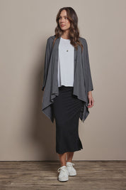 Model Madeline wearing size 10 of The Pack & Go Luxe Bamboo Pull On Maxi Skirt in colour Black (Black), from the front, showing the whole outfit
