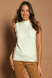 Model Madeline wearing size S of The Modal Blend Mockturtle Vest in colour White (White), from the front, cropped image