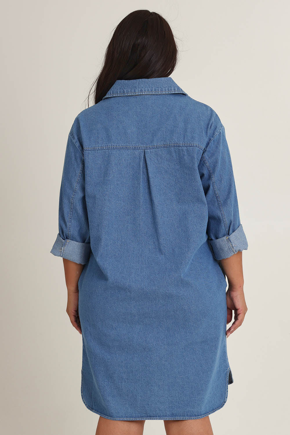Model Ashleigh wearing size 16 of The Denim Shacket Dress With Pockets in colour Denimblue (Blue), from the back