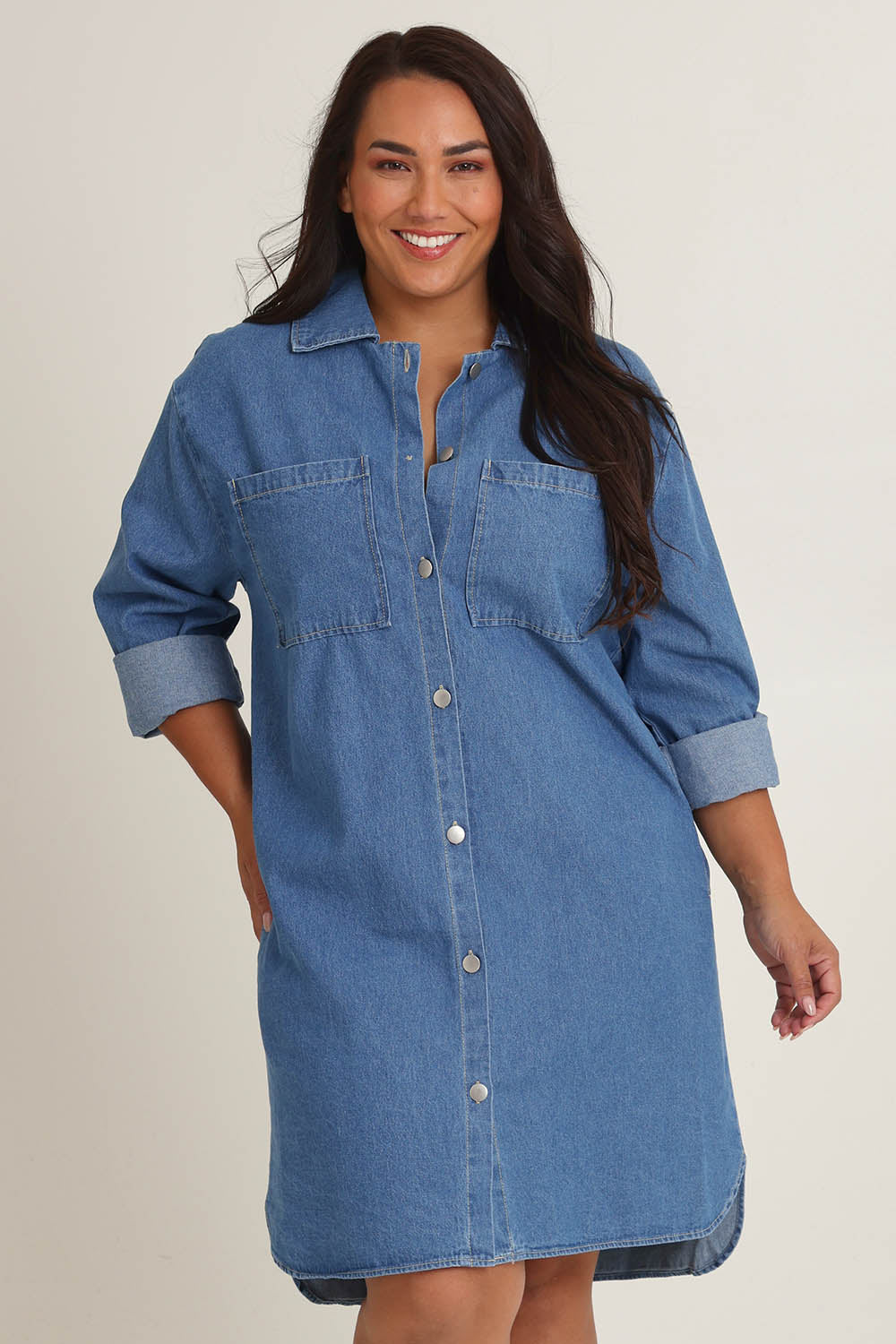 Model Ashleigh wearing size 16 of The Denim Shacket Dress With Pockets in colour Denimblue (Blue), from the front, cropped image