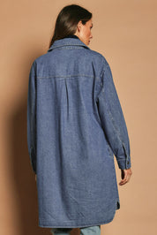 Model Madeline wearing size 10 of The Denim Shacket Dress With Pockets in colour Denimblue (Blue), from the back