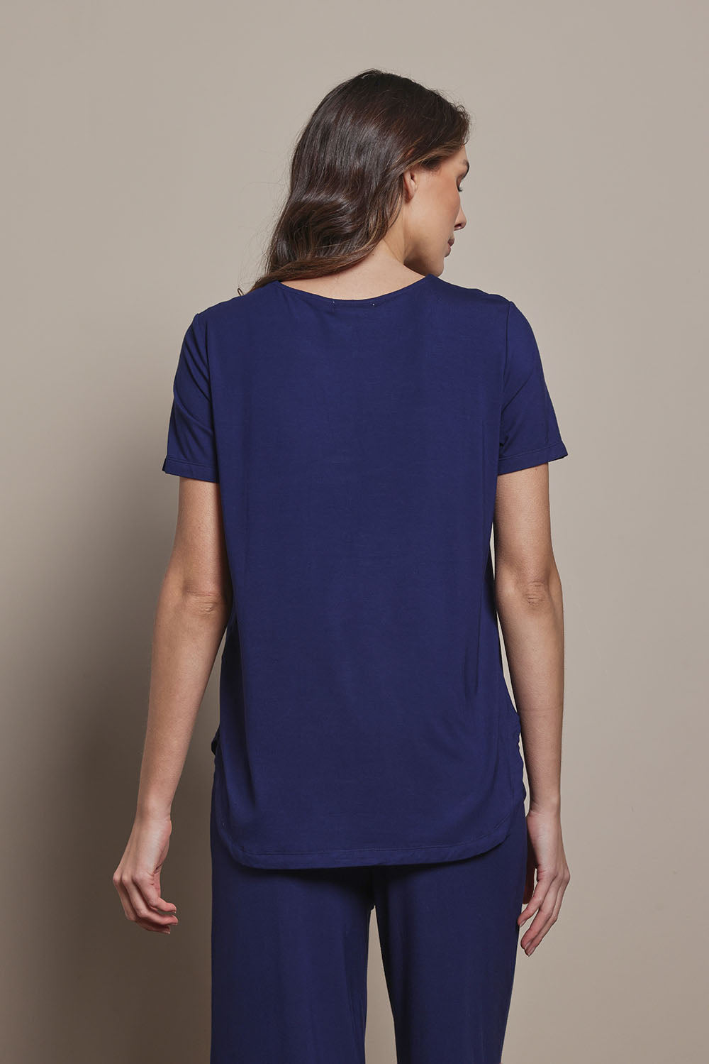 Model Madeline wearing size 10 of The Pack & Go Luxe Bamboo Tee in colour Frenchnavy (Blue), from the back