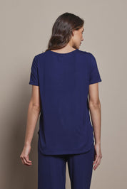 Model Madeline wearing size 10 of The Pack & Go Luxe Bamboo Tee in colour Frenchnavy (Blue), from the back