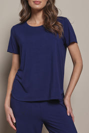 Model Madeline wearing size 10 of The Pack & Go Luxe Bamboo Tee in colour Frenchnavy (Blue), from the front, cropped image