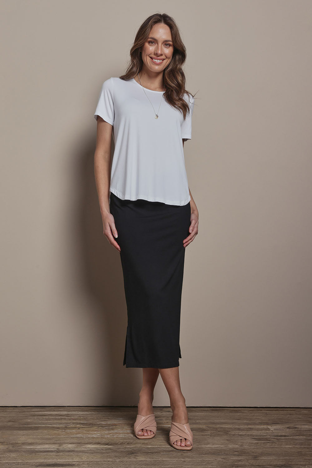 Model Madeline wearing size 10 of The Pack & Go Luxe Bamboo Tee in colour White (White), from the front, showing the whole outfit