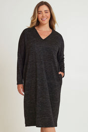 Model Chanel wearing size 16 of The Relaxed L/S Tee Dress With Pockets in colour Blackmarle (Black), from the front, cropped image