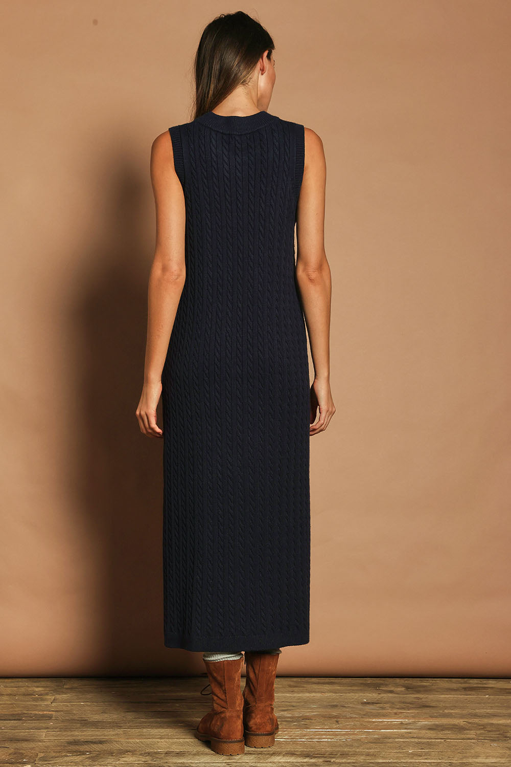 Model Madeline wearing size S of The Mock Turtle Cable Maxi Dress in colour Darknavy (Blue), from the back