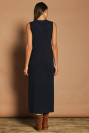 Model Madeline wearing size S of The Mock Turtle Cable Maxi Dress in colour Darknavy (Blue), from the back