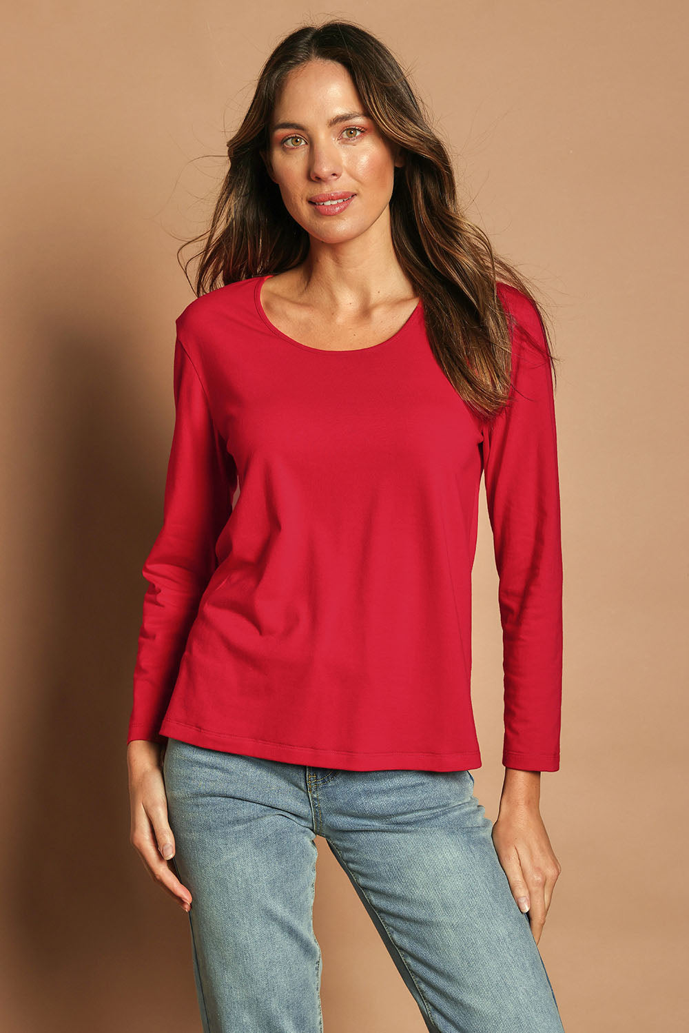 Model Madeline wearing size 10 of The Classic Long Sleeve Tee in colour Red (Red), from the front, cropped image