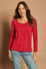 Model Madeline wearing size 10 of The Classic Long Sleeve Tee in colour Red (Red), from the front, cropped image