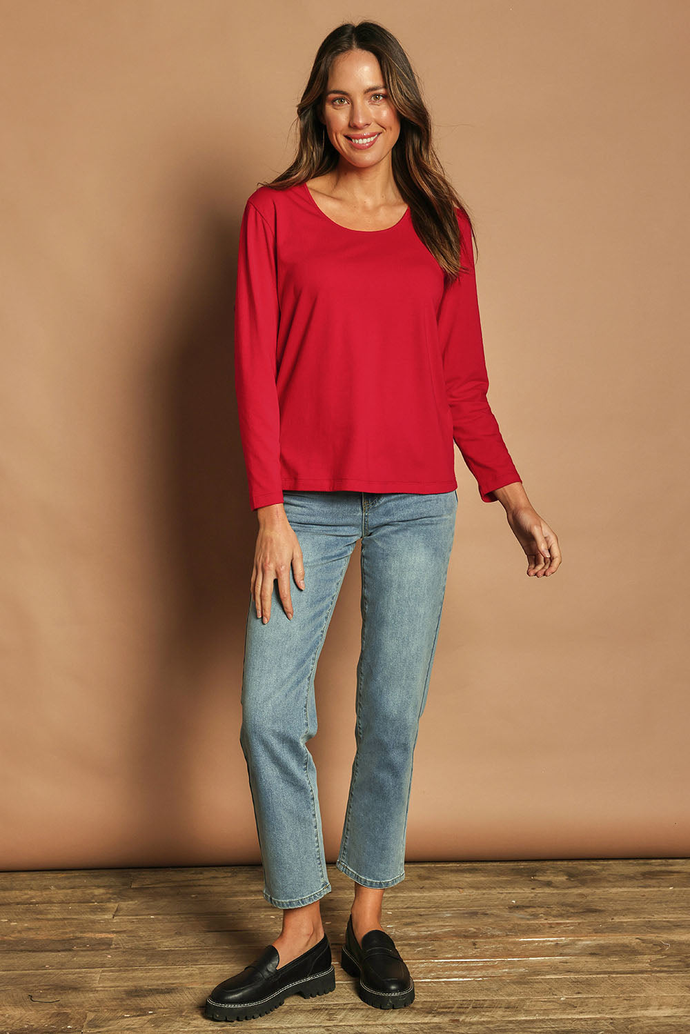 Model Madeline wearing size 10 of The Classic Long Sleeve Tee in colour Red (Red), from the front, showing the whole outfit