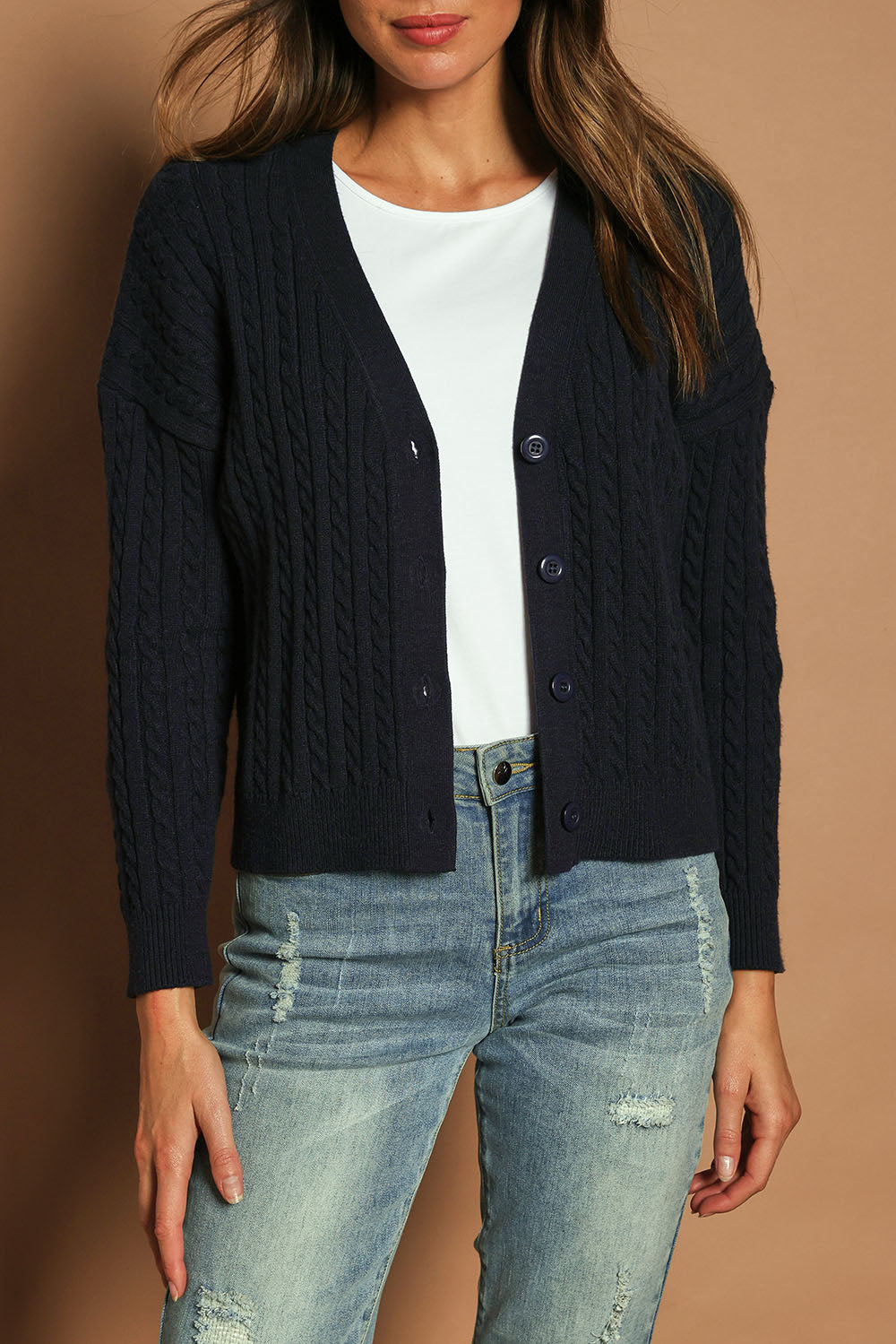 Model Madeline wearing size S of The Cable Knit Button Up Cardigan in colour Darknavy (Blue), from the front, cropped image