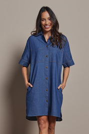 Model Amanda wearing size 10 of The S/S Chambray Shacket Dress With Pockets in colour Denim (Blue), from the front, cropped image