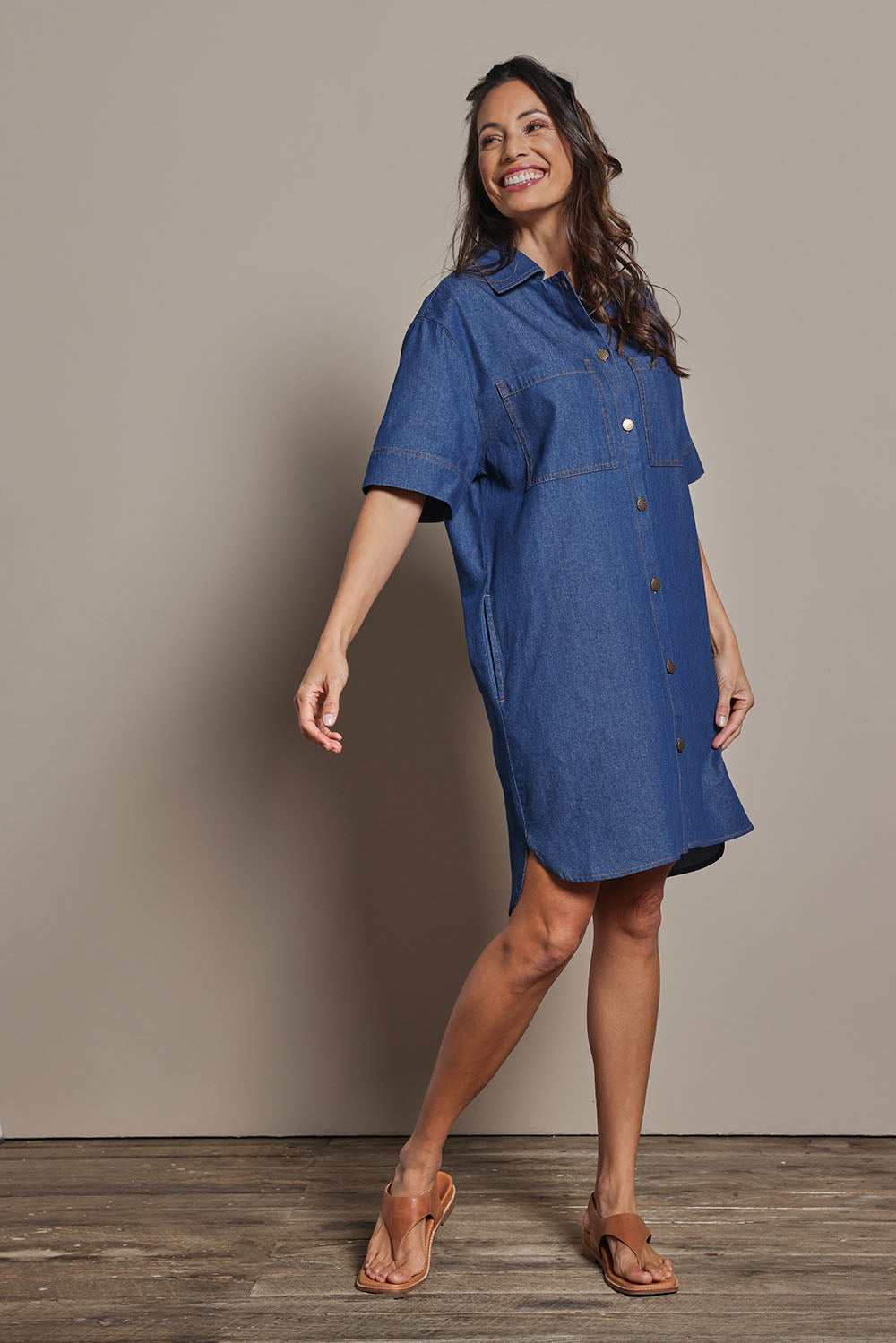 Model Amanda wearing size 10 of The S/S Chambray Shacket Dress With Pockets in colour Denim (Blue), from the front, showing the whole outfit