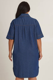 Model Ashleigh wearing size 16 of The S/S Chambray Shacket Dress With Pockets in colour Denim (Blue), from the back