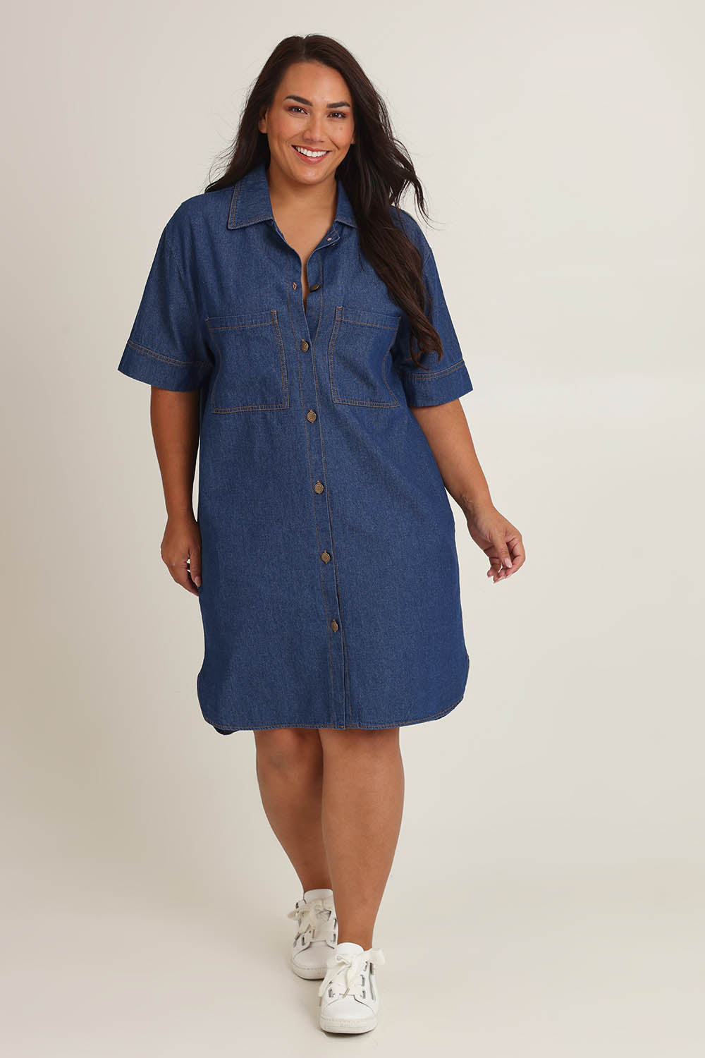 Model Ashleigh wearing size 18 of The S/S Chambray Shacket Dress With Pockets in colour Denim (Blue), from the front, showing the whole outfit