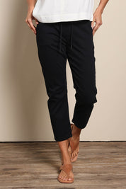 Model Amandam wearing size 10 of the The Pull On Cotton Pant With Drawstring – Black in colour Black, in a cropped view
