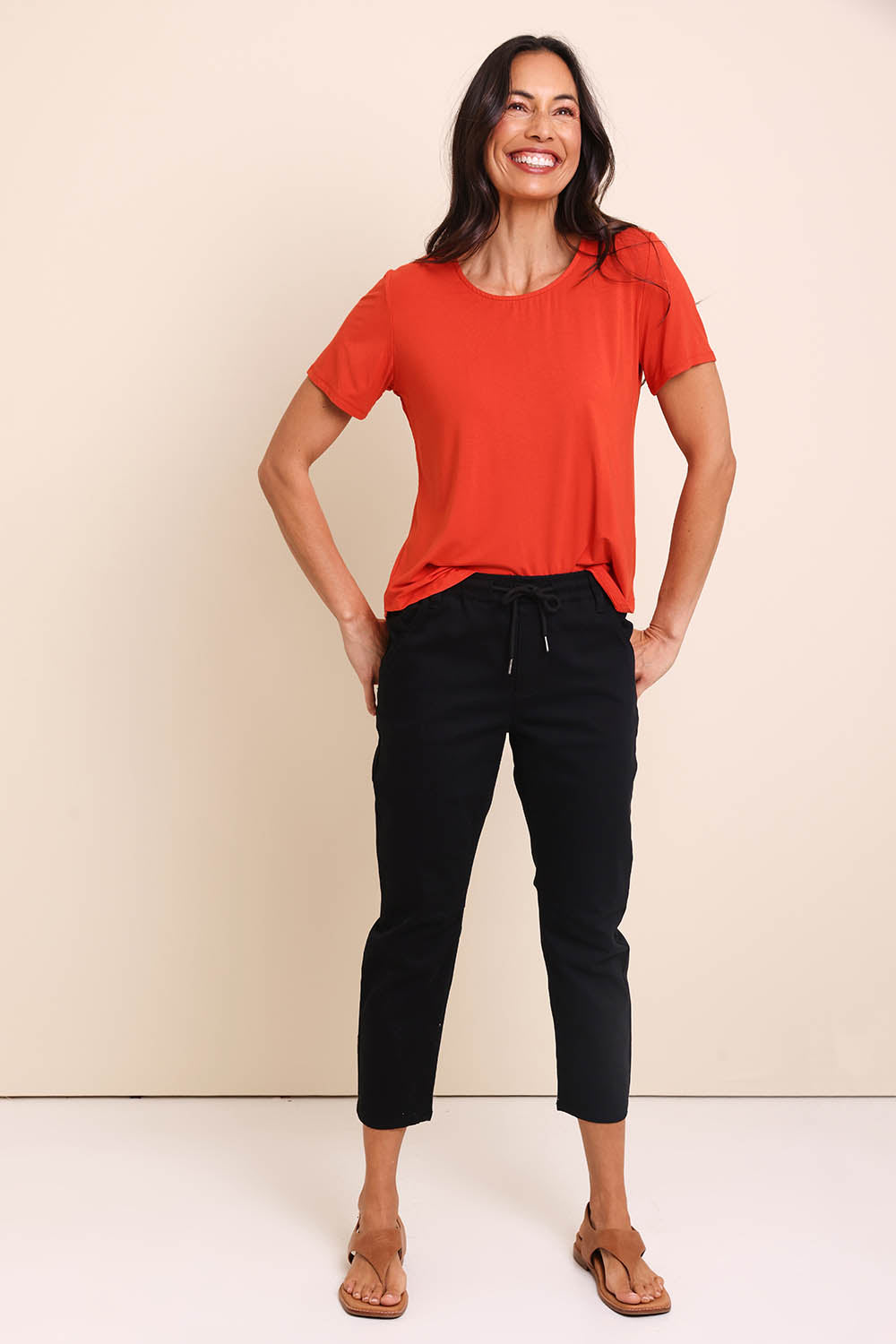 Model Amandam wearing size 10 of the The Pull On Cotton Pant With Drawstring – Black in colour Black, from the front