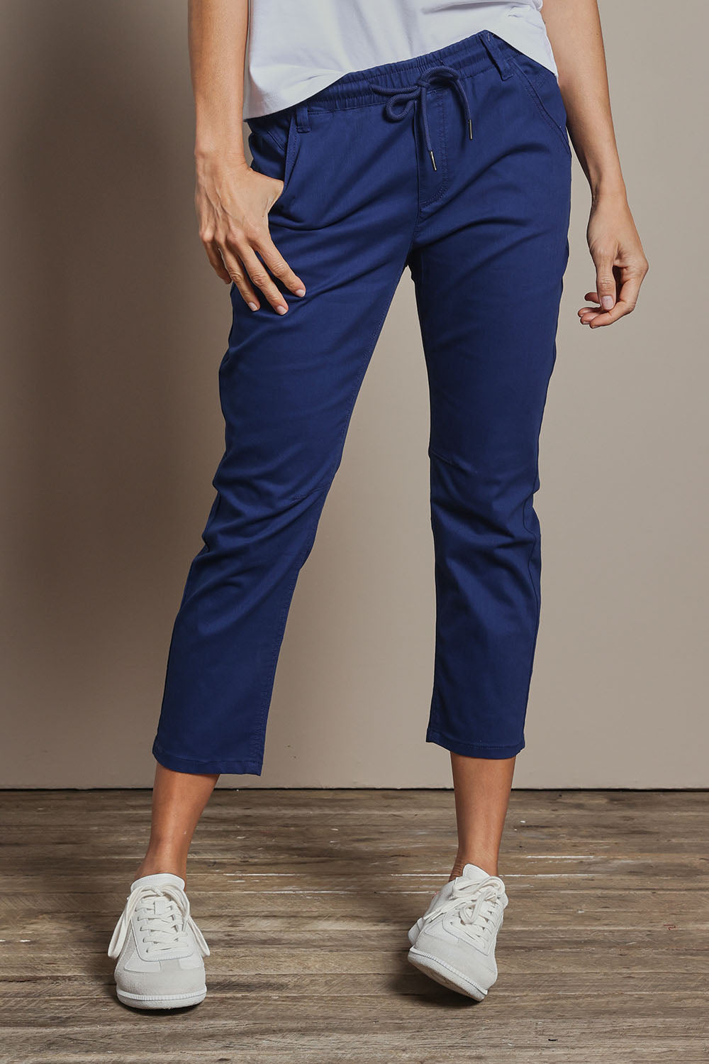 Model Amanda wearing size 10 of The Pull On Cotton Pant With Drawstring in colour Indigo (Blue), from the front, cropped image