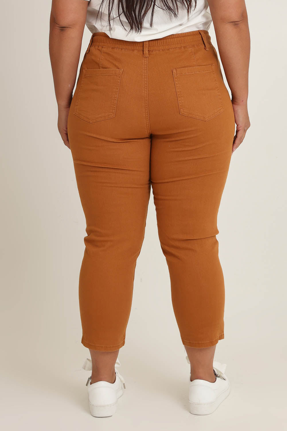 Model Ashleigh wearing size 16 of The Pull On Cotton Pant With Drawstring in colour Rust, from the back