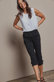 Model Amanda wearing size 10 of The Pull On Elastic Waist Cotton Blend Capri Pant in colour Black (Black), from the front, showing the whole outfit
